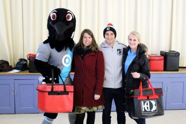 MN United player and mascot delivering Meals on Wheels