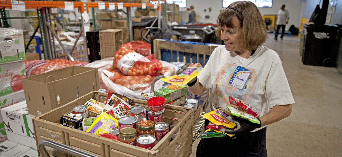 Volunteer sorting food donations in the warehouse