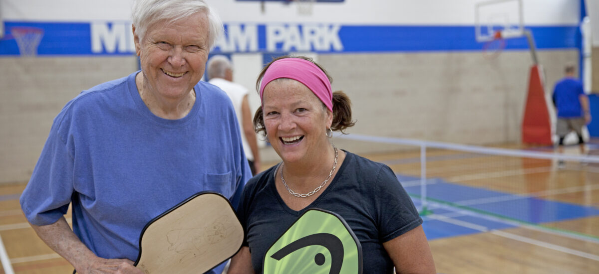 Older adults playing Pickleball